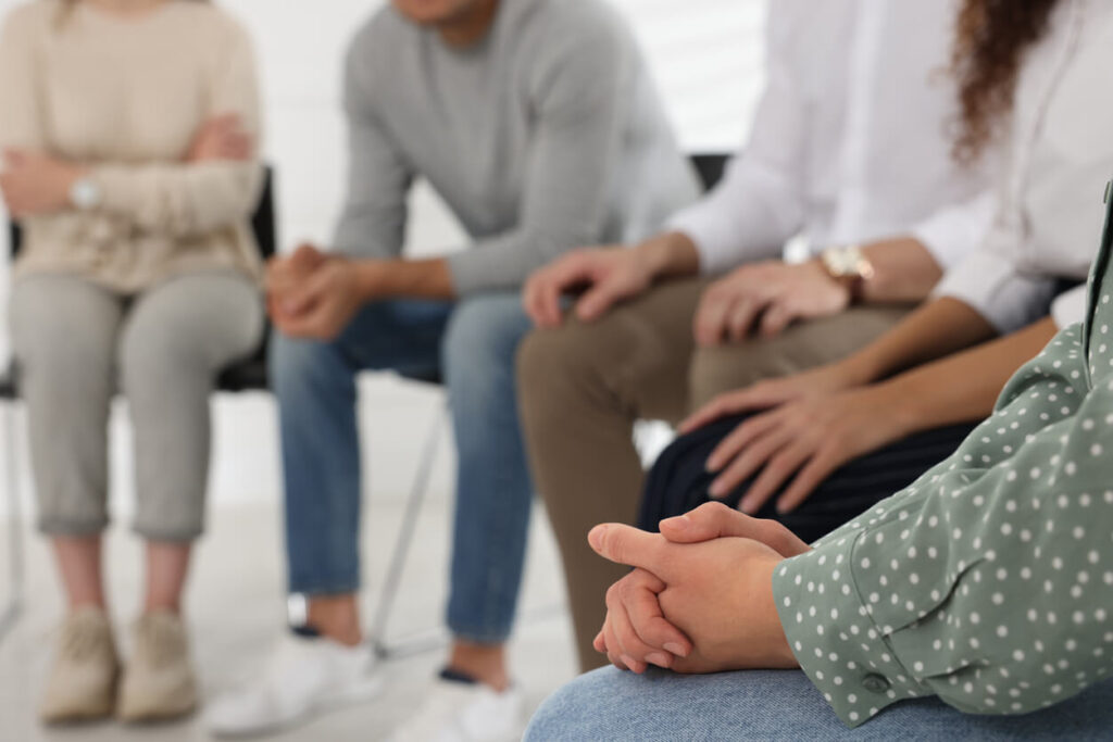 A group of people sit in a circle during substance abuse treatment therapy with Diversus Health in Colorado Springs.